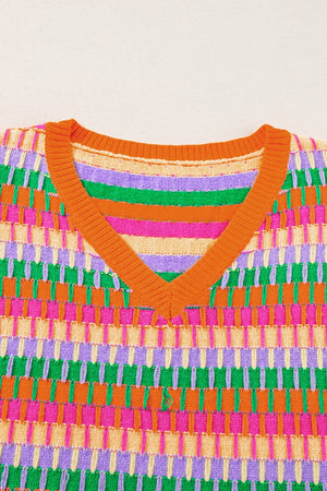 Geometric knit v-neck top in green and orange with multi-color stripes and textured pattern.