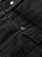 Black denim button-up dress with snap button chest pockets and raw hem detail.