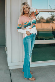 Crewneck shirt with Aztec print sleeves and striped sleeves in pink and white.