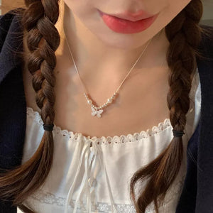 Charming butterfly and pearl necklace with delicate silver chain.