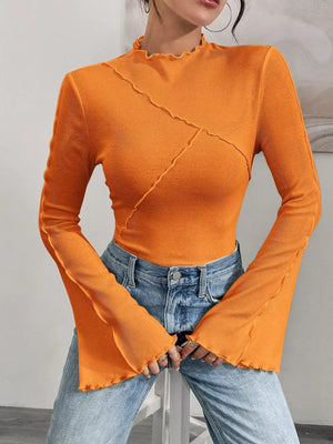 Orange lettuce edge flare sleeve t-shirt with seam detail and mock neck.