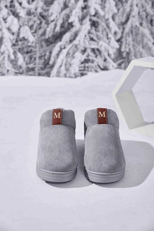 Gray suede house booties with shearling lining and maroon pull tabs.