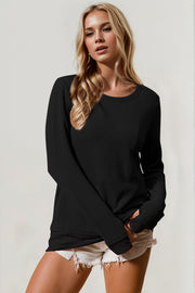 Black textured crew neck thermal top with long sleeves.