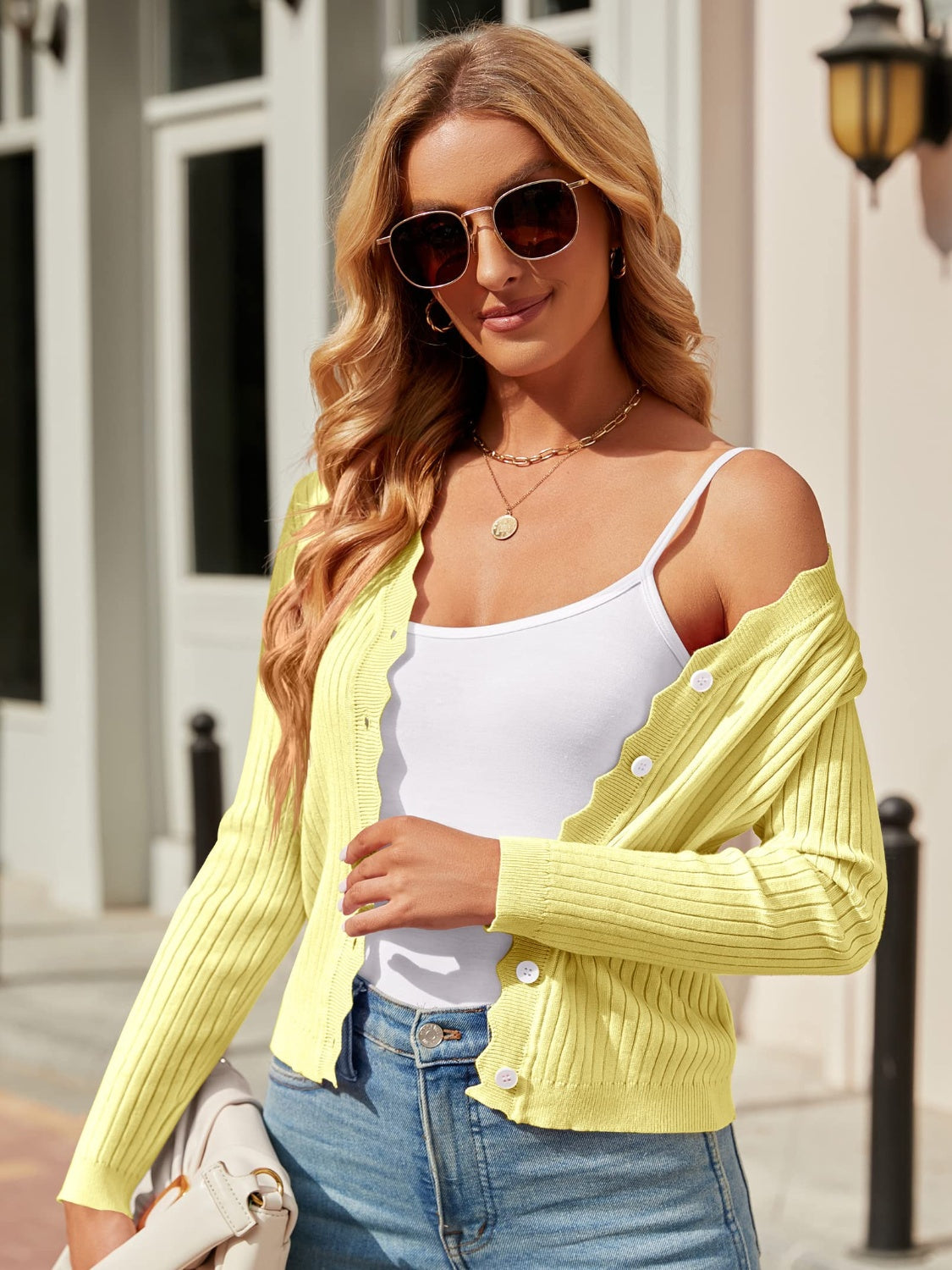Neon Yellow scalloped edge ribbed cardigan with button front and white buttons.
