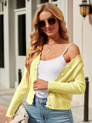 Neon Yellow scalloped edge ribbed cardigan with button front and white buttons.