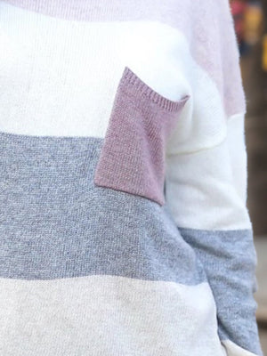 Colorblock knit sweater with a contrast pocket in stripe pattern.
