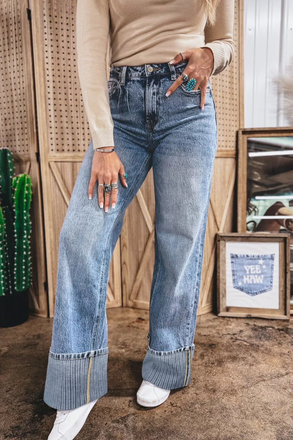 Cuffed mid-rise relaxed fit jeans in light wash denim with distressed details and a wide cuff.