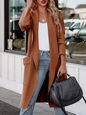 Caramel open-front duster cardigan with pockets, worn open over a white tank and jeans.