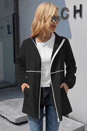 Black hooded rain coat with white trim and zipper detail.