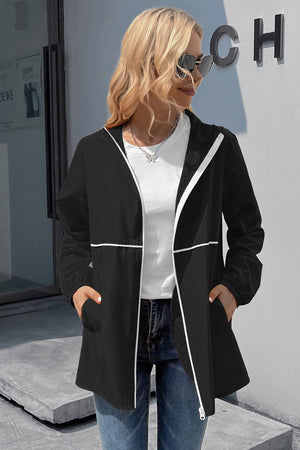 Black hooded rain coat with white trim and zipper detail.