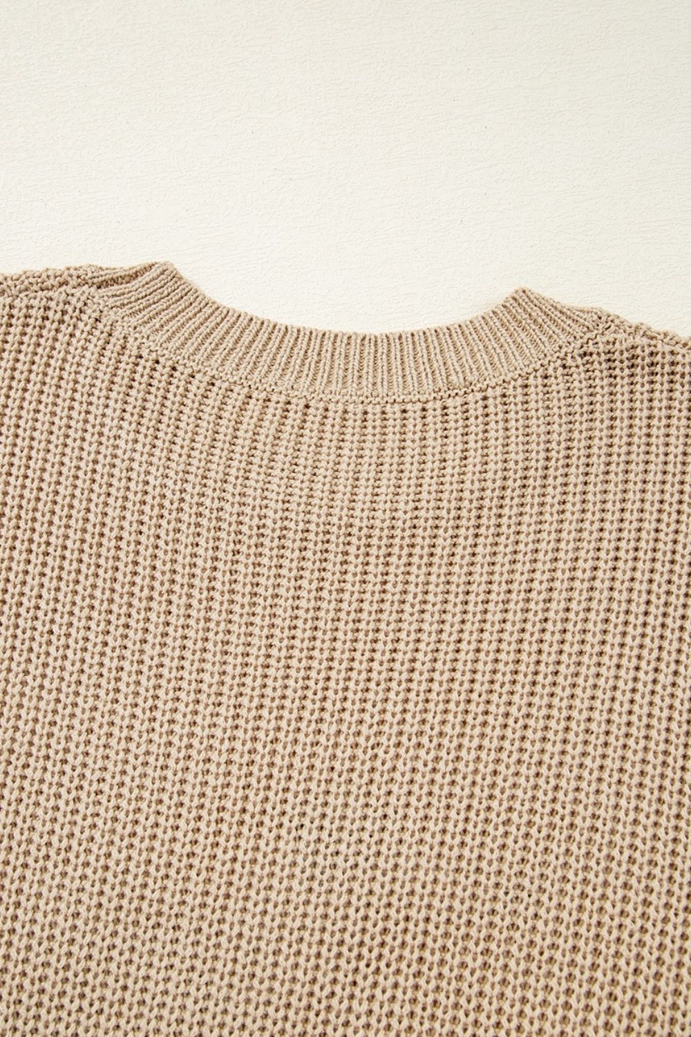 Tan acrylic knit tank top with crew neck and textured stitch detail.