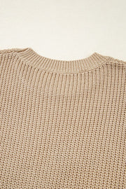 Tan acrylic knit tank top with crew neck and textured stitch detail.