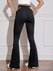Black flared high-waist active pants with bow emblem detail.