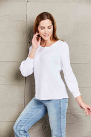 White ribbed knit sweater with boatneck and puff sleeves