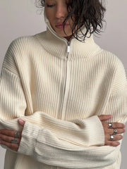 Cream ribbed knit zipper cardigan with a high neck and silver zipper detail