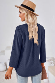 Dark blue textured henley shirt with roll-tab sleeves and a curved hem