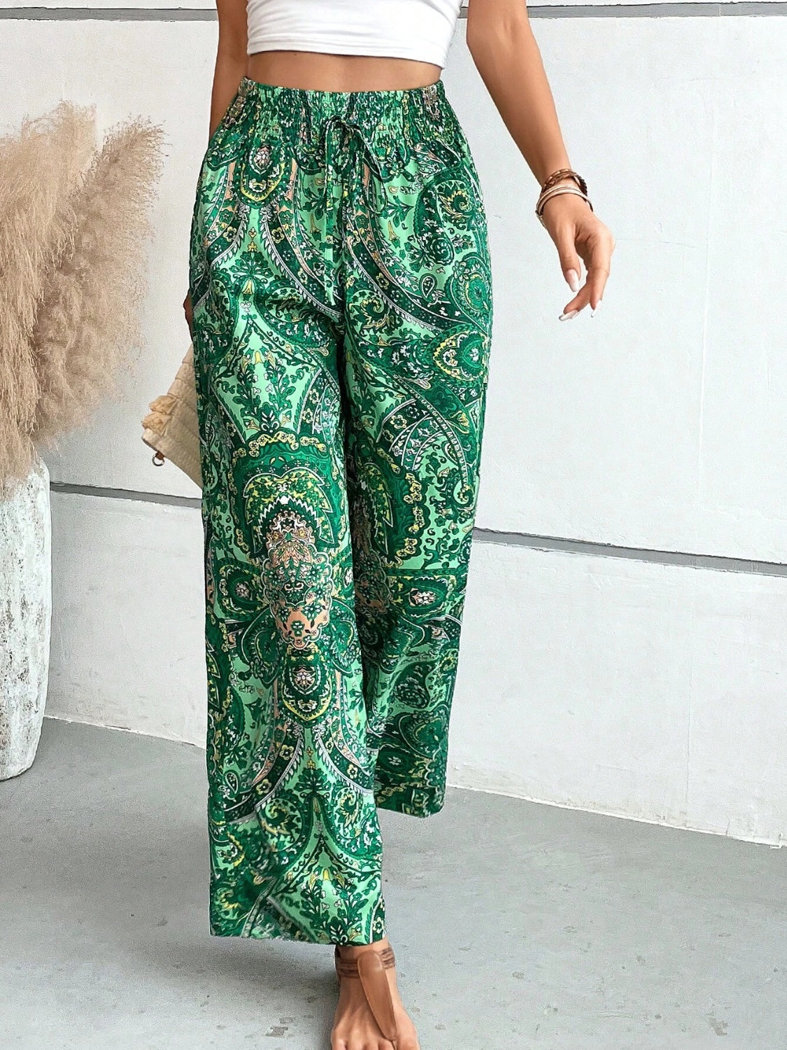 Paisley palazzo trousers in dark green with drawstring waist and wide leg