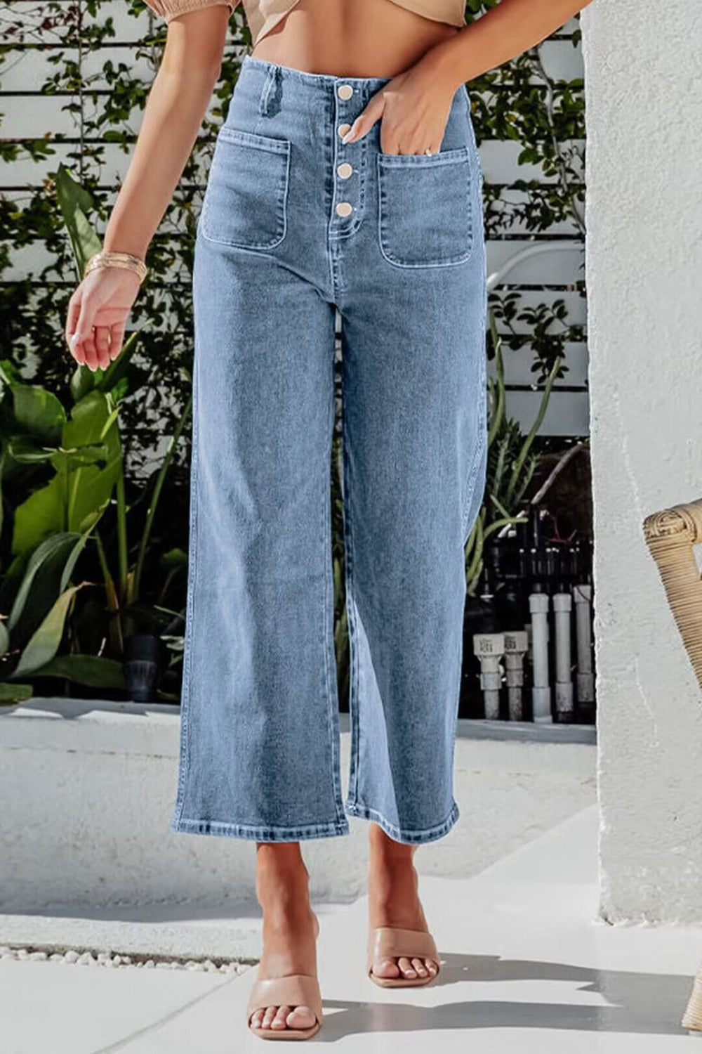 Button-front cropped wide-leg jeans in light blue denim with utility pockets.