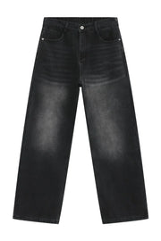 Oversized dark wash denim trousers with a faded effect and wide leg