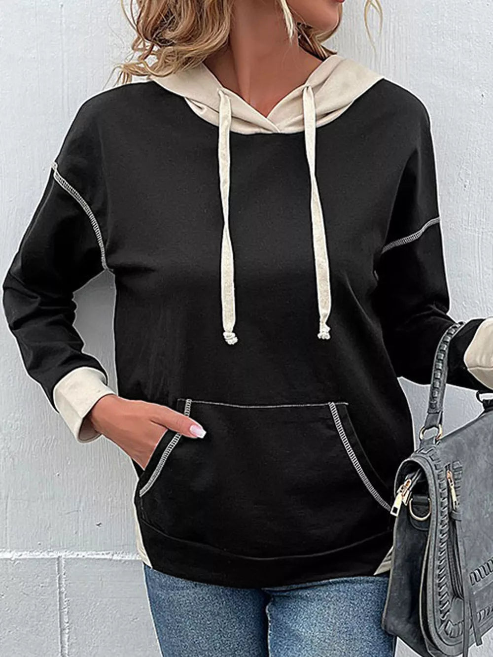 Black cotton hoodie with beige contrast details, drawstring, and contrast stitching.