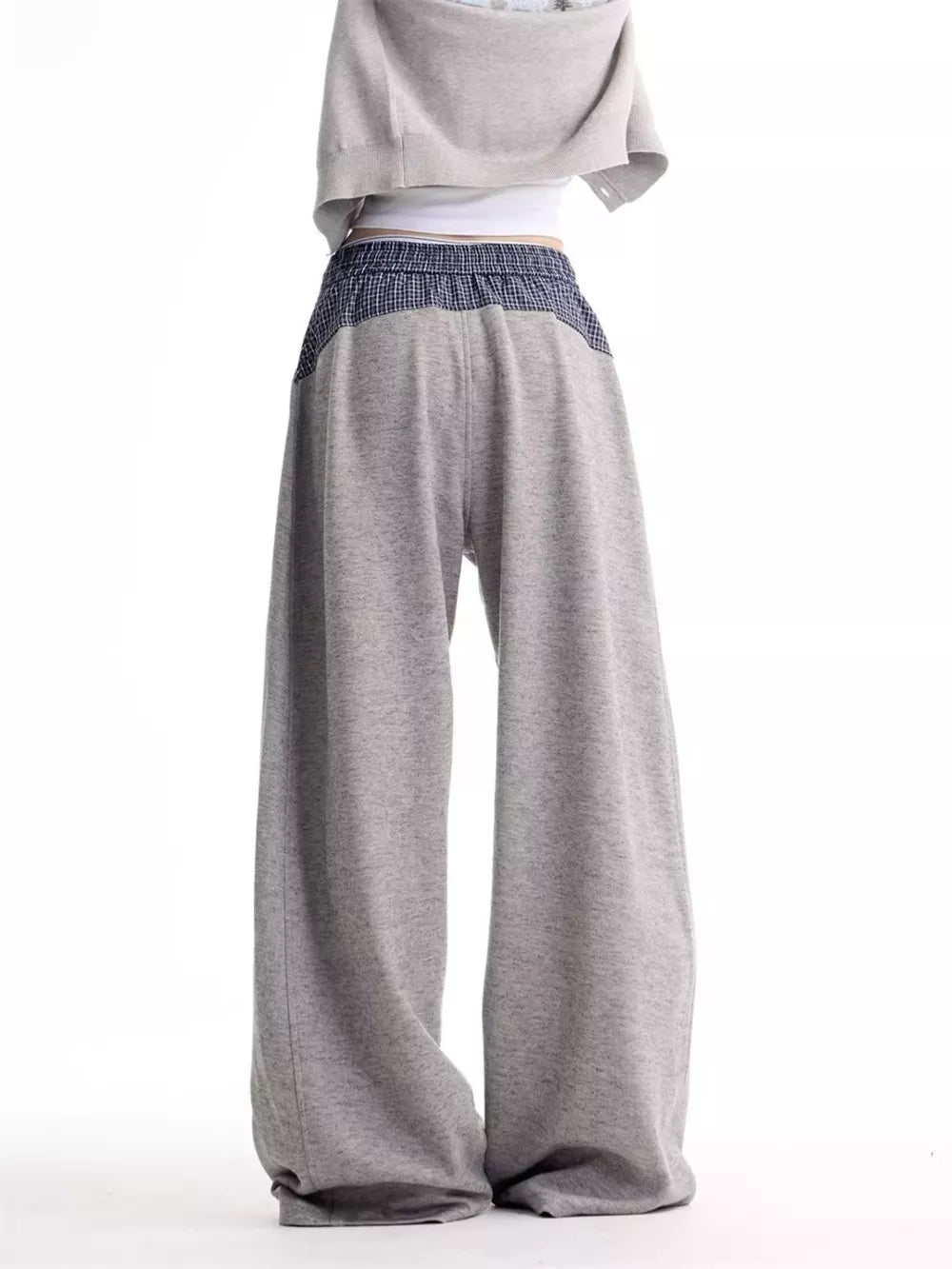 Grey wide-leg sweatpants with a blue plaid elastic waistband and side panels.