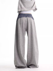 Grey wide-leg sweatpants with a blue plaid elastic waistband and side panels.
