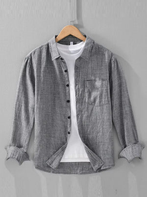 Grey textured linen long sleeve button-up shirt with a chest pocket, worn over a white tee.