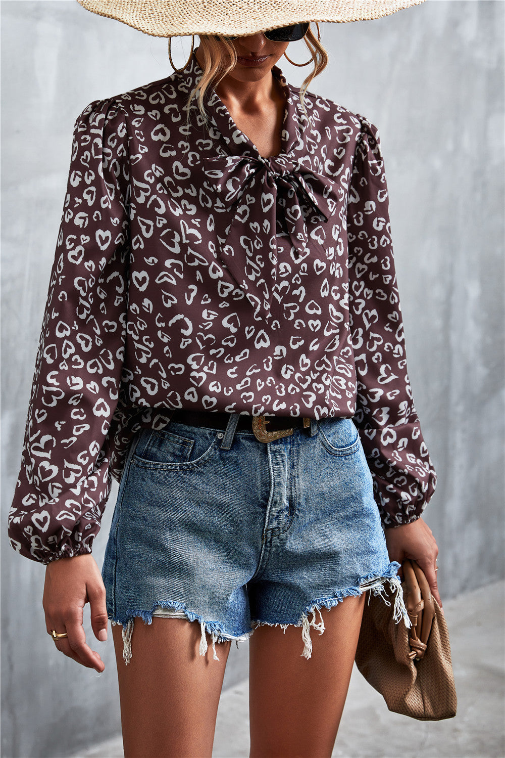 Brown abstract print pussy bow blouse with balloon sleeves.