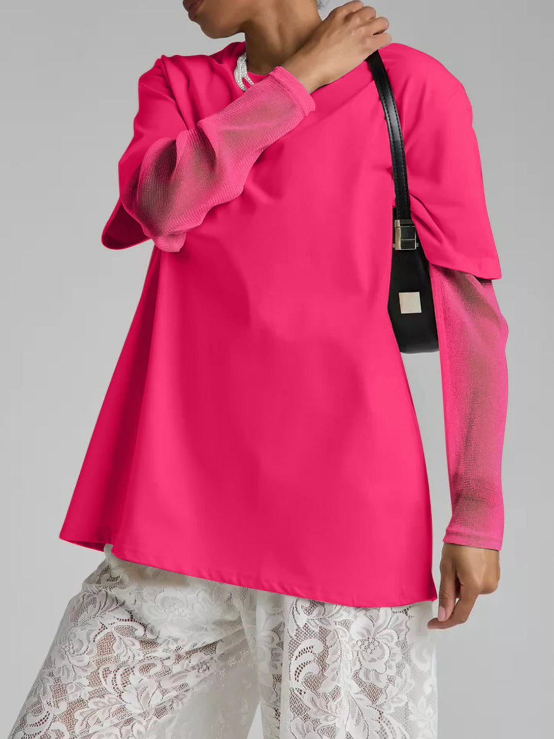 Hot pink oversized tee with sheer long sleeves and a flared hem.