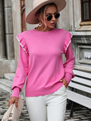Pink crew neck sweater with contrast ruffle shoulder detail and long sleeves.