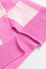 Fuchsia pink checkered knit sweater with polo neckline and ribbed details.