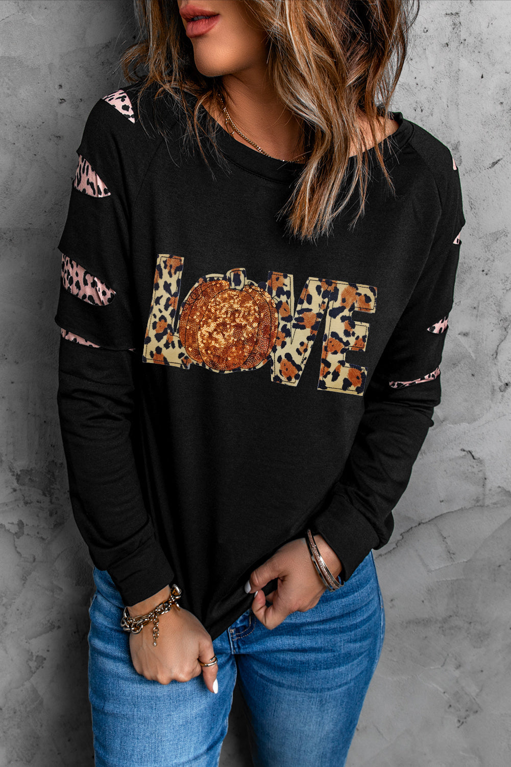 Black sweatshirt with leopard print LOVE graphic and cutout sleeves.