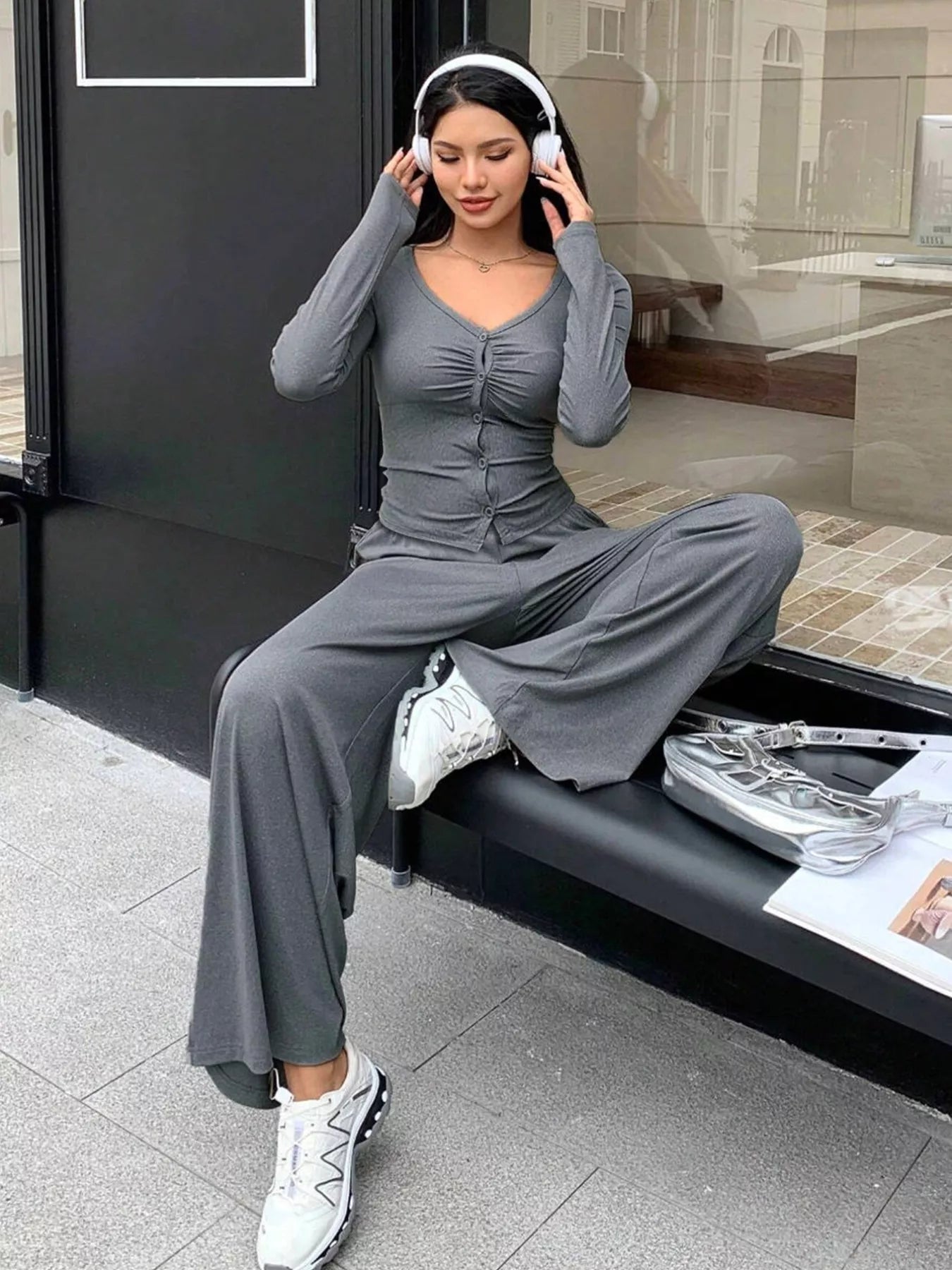 Gray ruched button-down top and wide-leg pants set with a v-neckline.