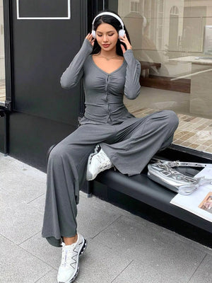 Gray ruched button-down top and wide-leg pants set with a v-neckline.
