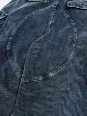 Textured blue corduroy cargo pants with functional pockets and seam details.