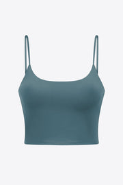 Turquoise scoop neck crop tank top with thin spaghetti straps.
