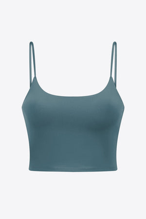 Turquoise scoop neck crop tank top with thin spaghetti straps.
