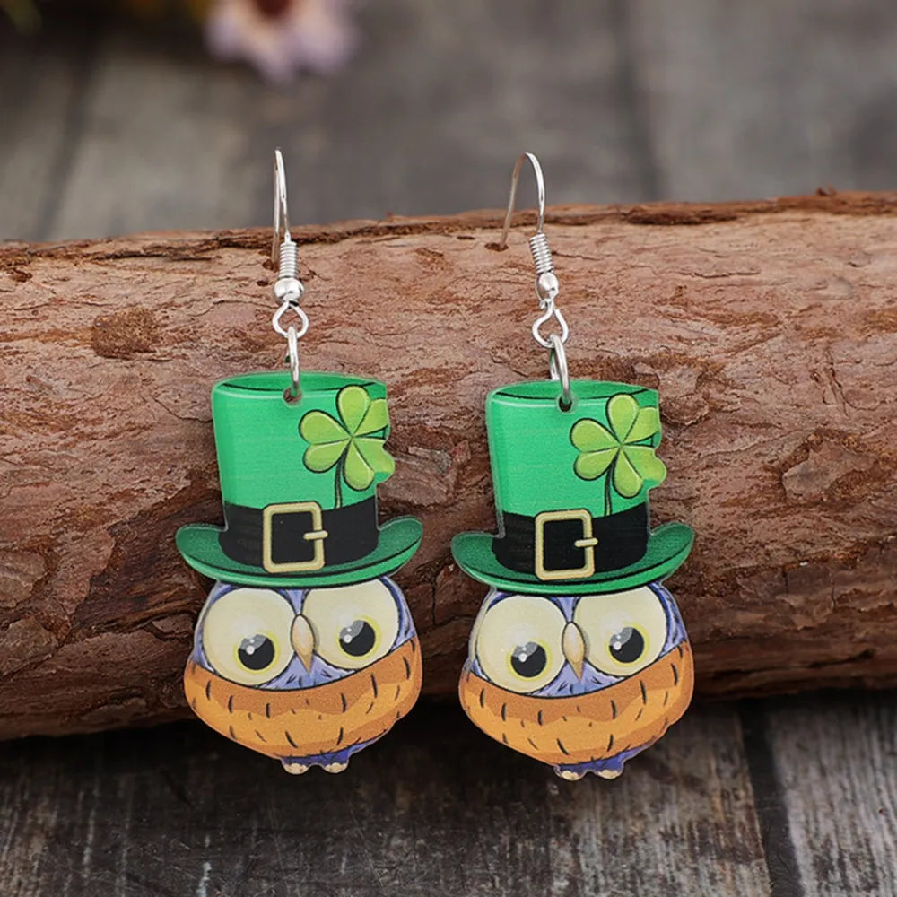 Lucky Owl Acrylic Dangle Earrings in green with shamrock hats and buckle detail.
