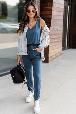 Peacock Blue relaxed drawstring waist jumpsuit with V-neck and pockets.