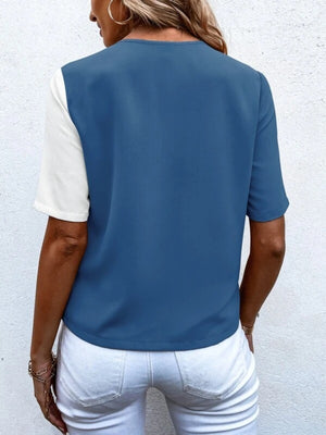 Two-tone dusty blue and white asymmetric button-down shirt with short sleeves.