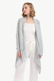 Gray asymmetric fringe knit cardigan with button detail and waterfall hem.