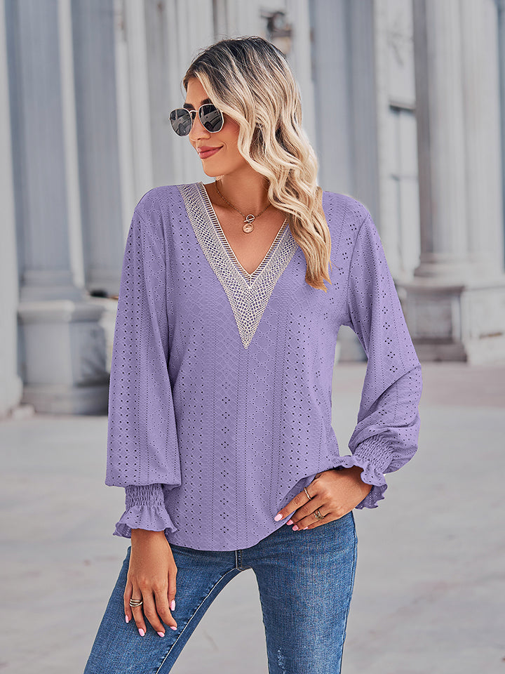 Periwinkle eyelet blouse with lace trim V-neck and ruffled cuffs.