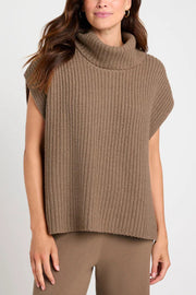 Sleeveless ribbed turtleneck sweater in taupe acrylic, styled casually.