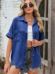 Relaxed denim shirt jacket in medium blue with short sleeves and two chest pockets.