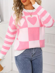 Blush pink and white checkerboard knit sweater with heart details and striped sleeves.