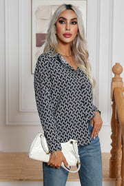 Black and white monogram print collared button-up blouse with long sleeves.