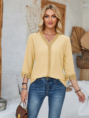 Light yellow eyelet blouse with V-neck and lace trim details.