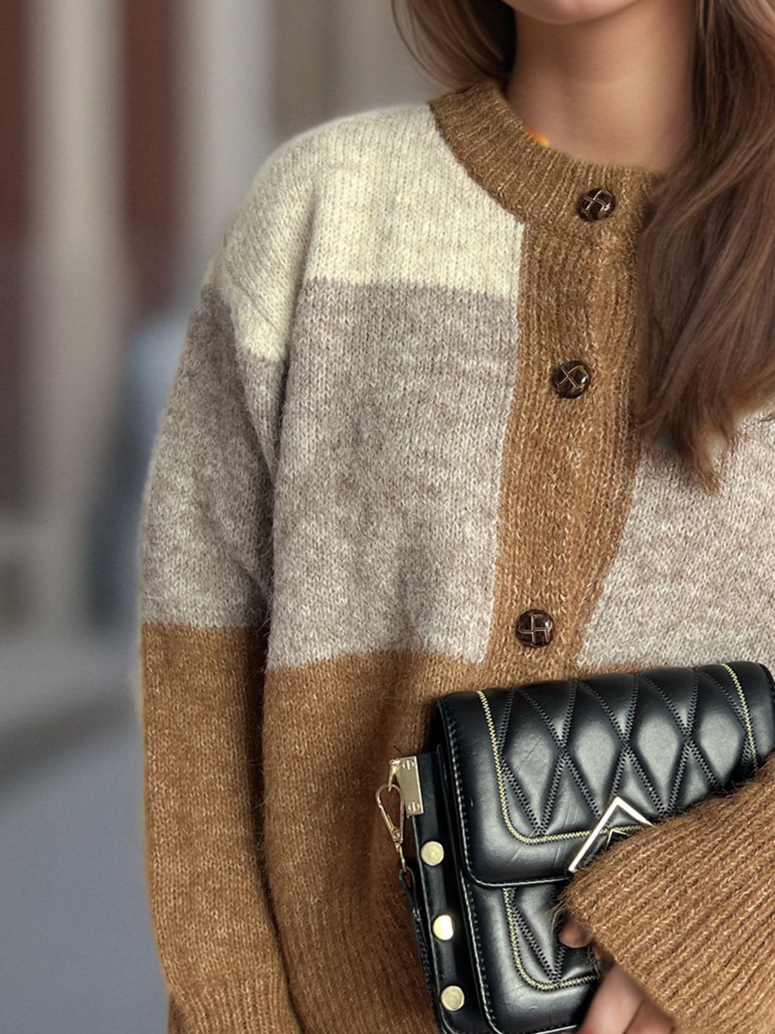 Colorblock crewneck button-down acrylic cardigan in beige and caramel tones.