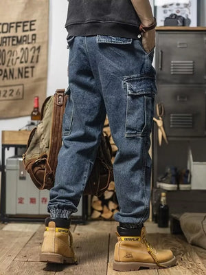 Men's vintage wash blue denim cargo jeans with multiple pockets and cuffed ankles.