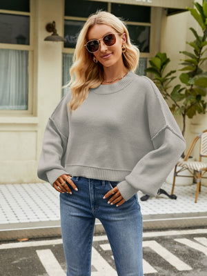 Dropped shoulder knit sweater in Heather Gray with balloon sleeves and a crew neck.